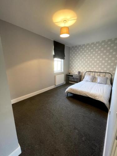 a bedroom with a bed and a window at Spacious Flat in Aberdeenshire in Insch