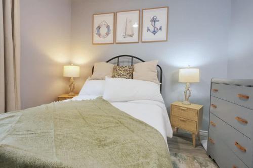 a bedroom with a bed and two lamps and a dresser at 1BR Backyard Bliss - Apt 6 in Bridgewater