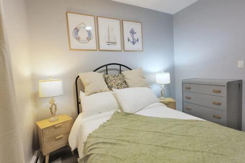 a bedroom with a bed and a dresser with two lamps at 1BR Backyard Bliss - Apt 6 in Bridgewater