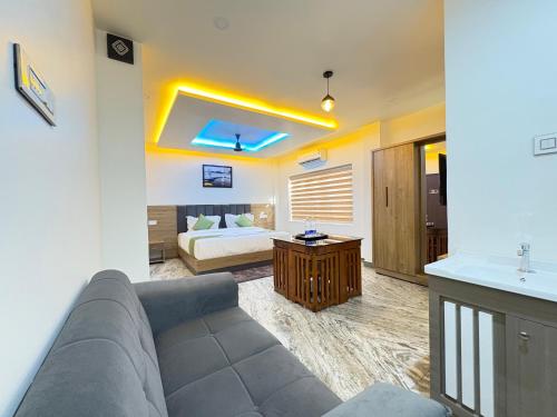 a living room with a couch and a bed at Marhaba plaza in Kozhikode