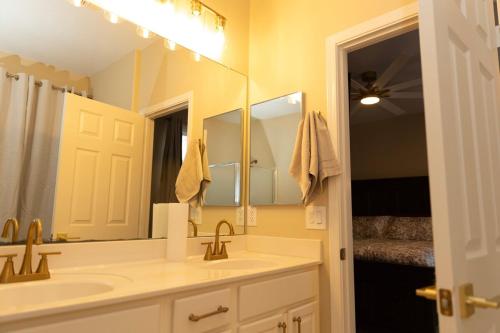 a bathroom with a sink and a large mirror at The Margarita in Phoenix
