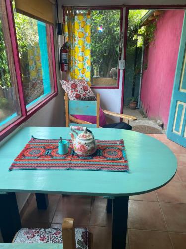 a blue table with a tea set on it in a room at Lugar bonito casa de dos habitaciones in El Bolsón