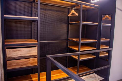 a walk in closet with wooden shelves at The Coffee Club Apartahotel in Manizales