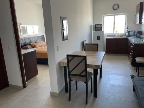 a kitchen and dining room with a table and a bedroom at Cabo Condos - Boutique Condos in Cabo San Lucas