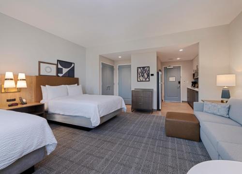 a hotel room with a bed and a couch at Staybridge Suites Miramar Beach - Sandestin Area by IHG in Destin