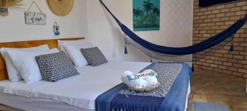a bedroom with a hammock bed with a basket on it at Pousada Ventoria in Canguaretama