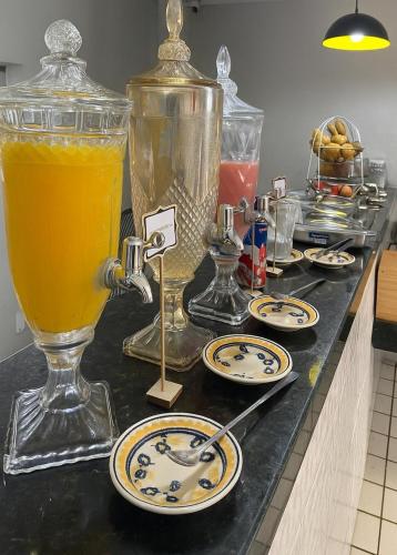 un comptoir avec des assiettes et un pichet en verre de jus dans l'établissement Pousada Serra Bella, à Tianguá
