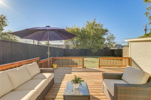a patio with two couches and an umbrella at Walk to Cultural District Fort Worth Home with Yard in Fort Worth