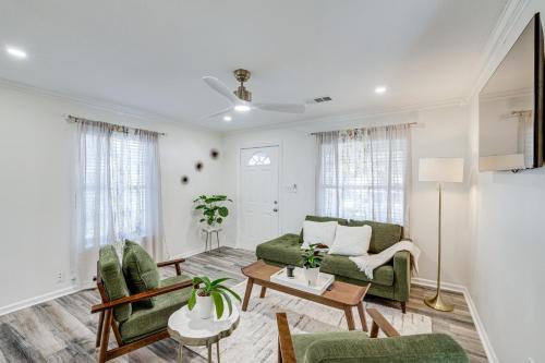 a living room with a green couch and chairs at Walk to Cultural District Fort Worth Home with Yard in Fort Worth