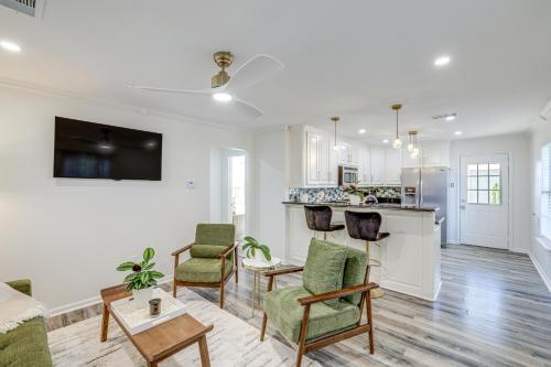a living room with white walls and a kitchen at Walk to Cultural District Fort Worth Home with Yard in Fort Worth