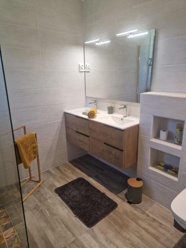 a bathroom with a sink and a mirror at La Casa Bongo - T4 cosy en pleine nature in Capesterre-Belle-Eau
