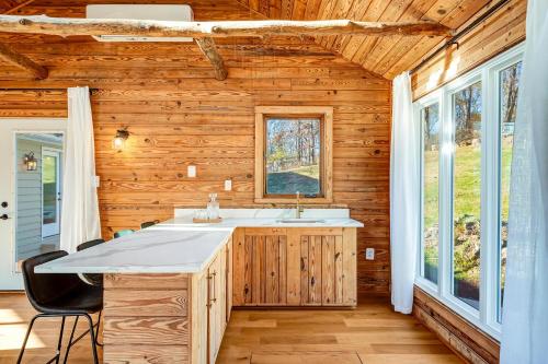 a bathroom with a sink in a log cabin at Woodhaven Reserve by STREAM in Purcellville