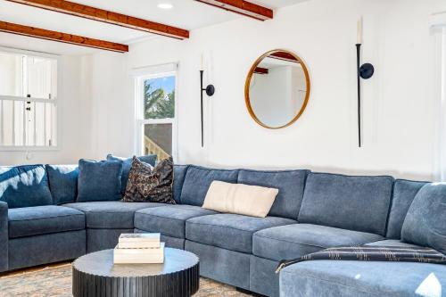 a living room with a blue couch and a table at Woodhaven Reserve by STREAM in Purcellville