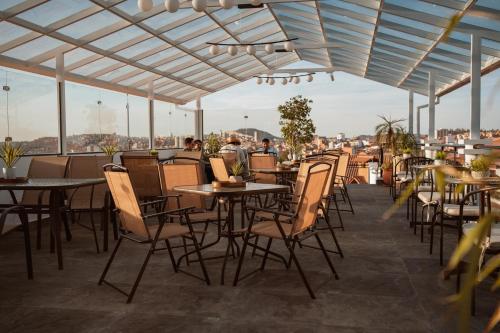 a row of tables and chairs on a patio at Hotel Qhawarina de Casas Kolping Bolivia S.R.L. in Sucre
