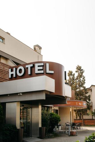 a hotel sign on the side of a building at Hotel Olimpia in Imola