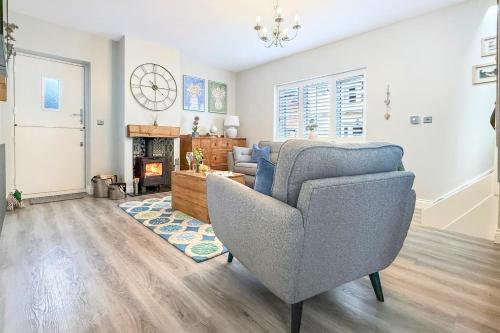 a living room with a couch and a chair at Central, dog friendly, private courtyard in Edwinstowe