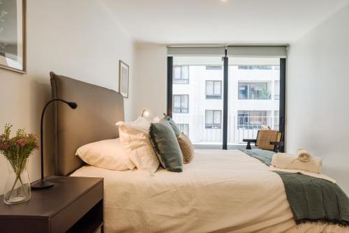 Ένα ή περισσότερα κρεβάτια σε δωμάτιο στο 8550 Las Condes Suites by Andes STR