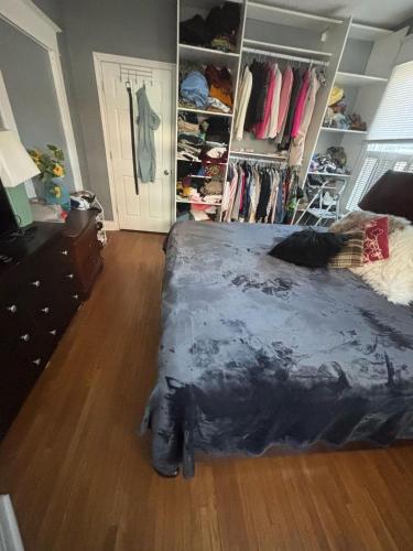 a bedroom with a bed and a wooden floor at Woodbridge Heritage Home in Vaughan
