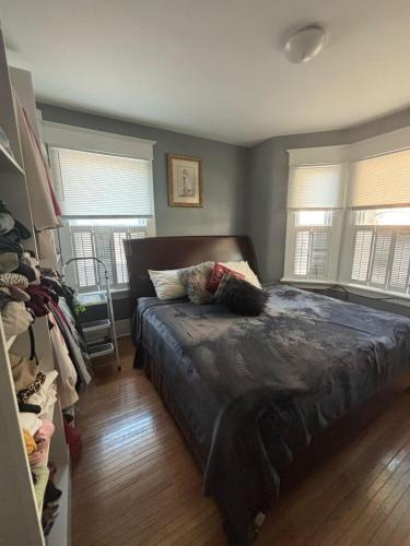 a bedroom with a bed and two windows at Woodbridge Heritage Home in Vaughan