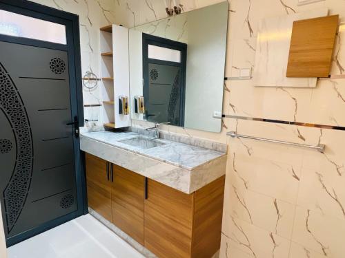 a bathroom with a sink and a mirror at Heart of Dakhla Residence in Dakhla