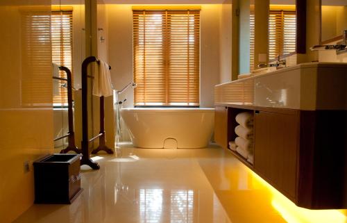 a bathroom with a tub and a toilet and a sink at Tanjung Rhu Resort in Tanjung Rhu 