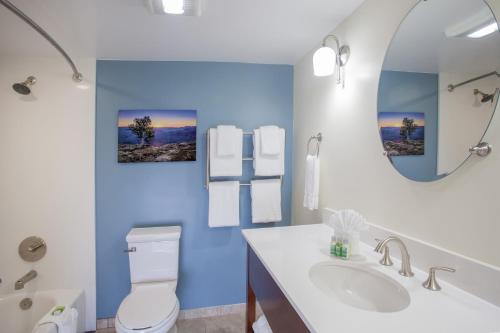 a bathroom with a white toilet and a mirror at Red Feather Lodge/Hotel in Tusayan