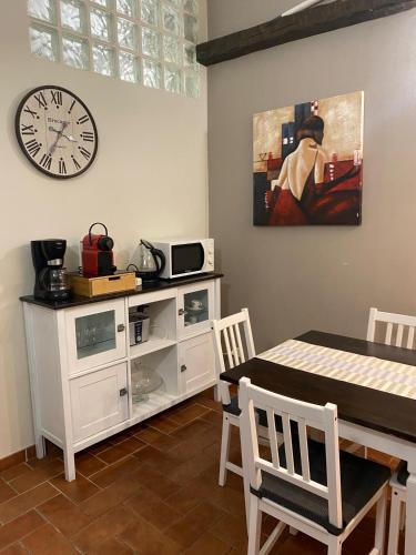 a dining room with a table and a clock on the wall at La Pieve di Luca in La Spezia