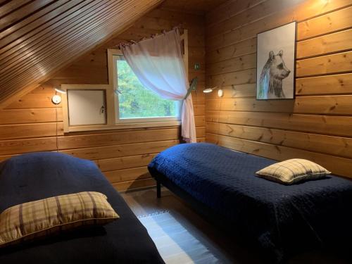 Postel nebo postele na pokoji v ubytování Tahkon Riihiranta - 4 bedroom villa by the lake - Tasokas tilava rantamökki