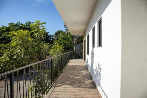 a balcony of a house with a fence and trees at Vista Sayulita in Sayulita