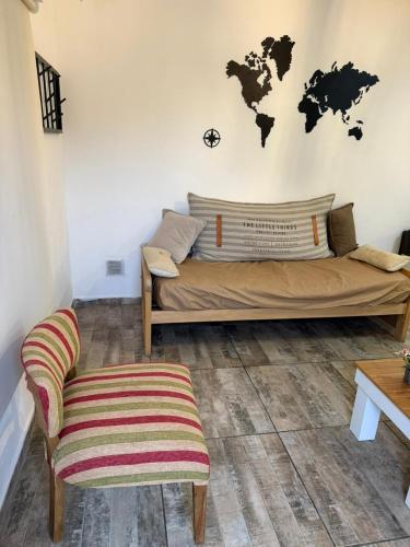 a bedroom with a bed and a world map on the wall at La posada de majo 2 in Pergamino