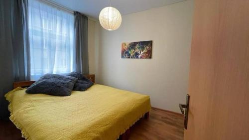 a bedroom with a bed with blue pillows on it at Pest Downtown Inn in Budapest