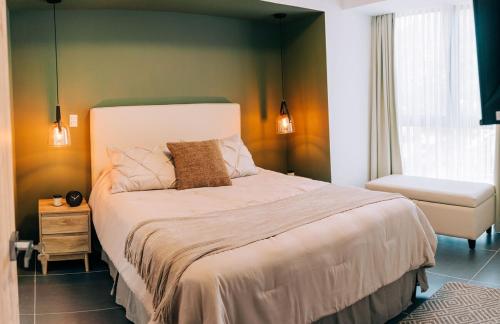 a bedroom with a large bed and a window at NEW Cozy&Modern Apt 30min from SurfCity in Hacienda Plan de La Laguna