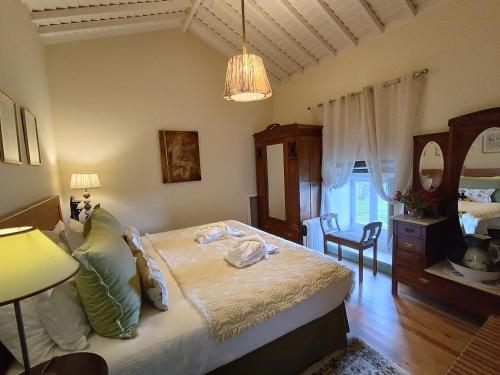a bedroom with a bed and a table and chairs at A Arribana in Nordestinho