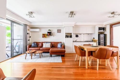 a living room with a couch and a table at 2 Royal Rest Quality 2BR West Perth-parking in Perth