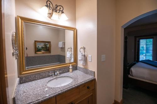 a bathroom with a sink and a mirror at Family Zermatt 2BR Villa with Kitchen & Pool Near Park City Ski Resorts - 7072 in Mound City