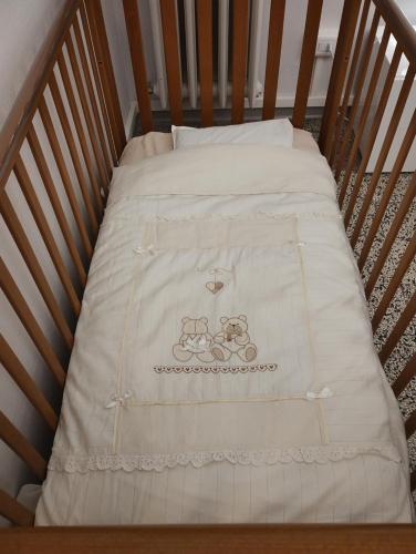 Una cama en una cuna con una manta. en Alloggio turistico, en Pisa