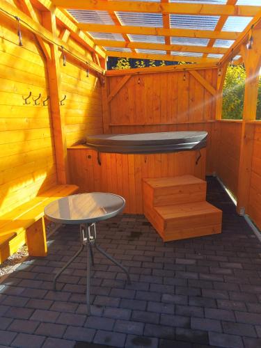 a sauna with a table and a bench in a cabin at Domek Lilijka-jacuzzi z widokiem na góry in Poronin