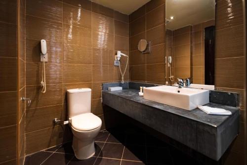 a bathroom with a sink and a toilet and a mirror at Rosa Boho Hotel And Aqua Park in Hurghada