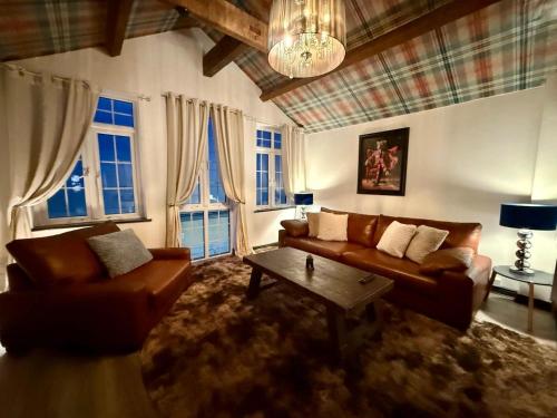 a living room with two couches and a table at The Coach House by The Hive WA1 in Warrington