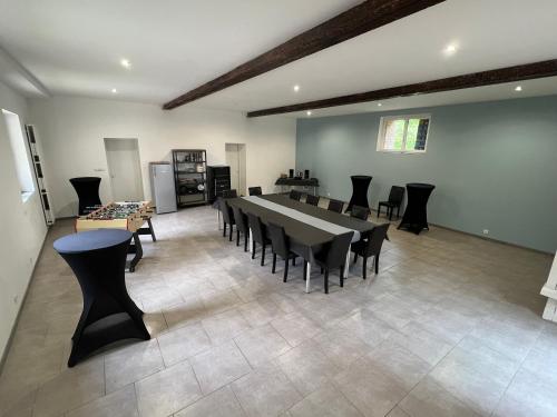a large dining room with a large table and chairs at La Laiterie 