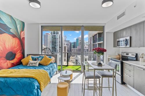 a bedroom with a bed and a kitchen with a window at Miami Penthouse Infinity Pool in Miami