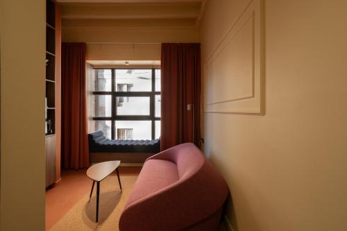 a living room with a couch and a window at OPERA Boutique Hotel & Restaurant & Bar in Rijeka
