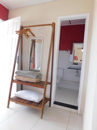 a mirror on a shelf in a bathroom at Pousada Luzes de Geribá in Búzios