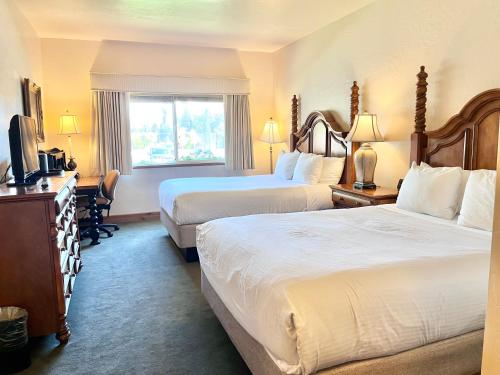 a hotel room with two beds and a television at Relaxing Double Queen Suite Near Park City & Sundance Ski Resorts - 1087 in Mound City