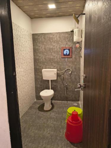 a bathroom with a toilet in a room at Sea view holiday resort in Borlai