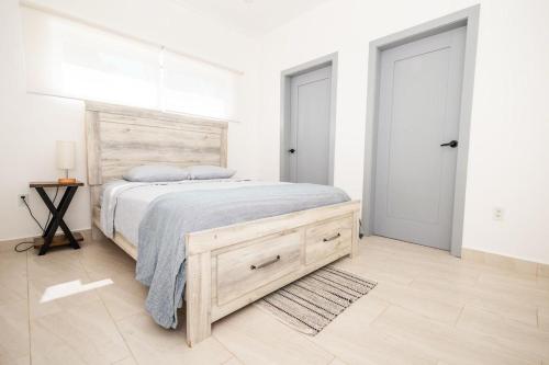 a bedroom with a large bed with a wooden headboard at Sunset Villas in Crawfish Rock