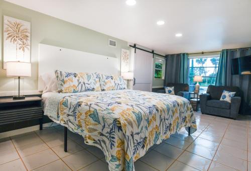 a bedroom with a large bed and a living room at Salty Shores Secluded Oasis in Englewood