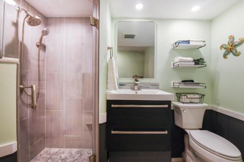 a bathroom with a toilet and a sink and a shower at Salty Shores Secluded Oasis in Englewood