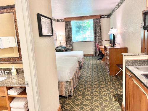 a hotel room with two beds and a bathroom at Alpine Double Queen Suite Near Park City & Deer Valley Ski Resorts - 134 in Mound City