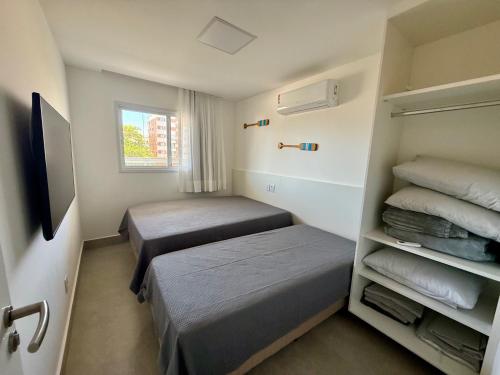 En eller flere senge i et værelse på Peracanga Bacutia Guarapari LS05